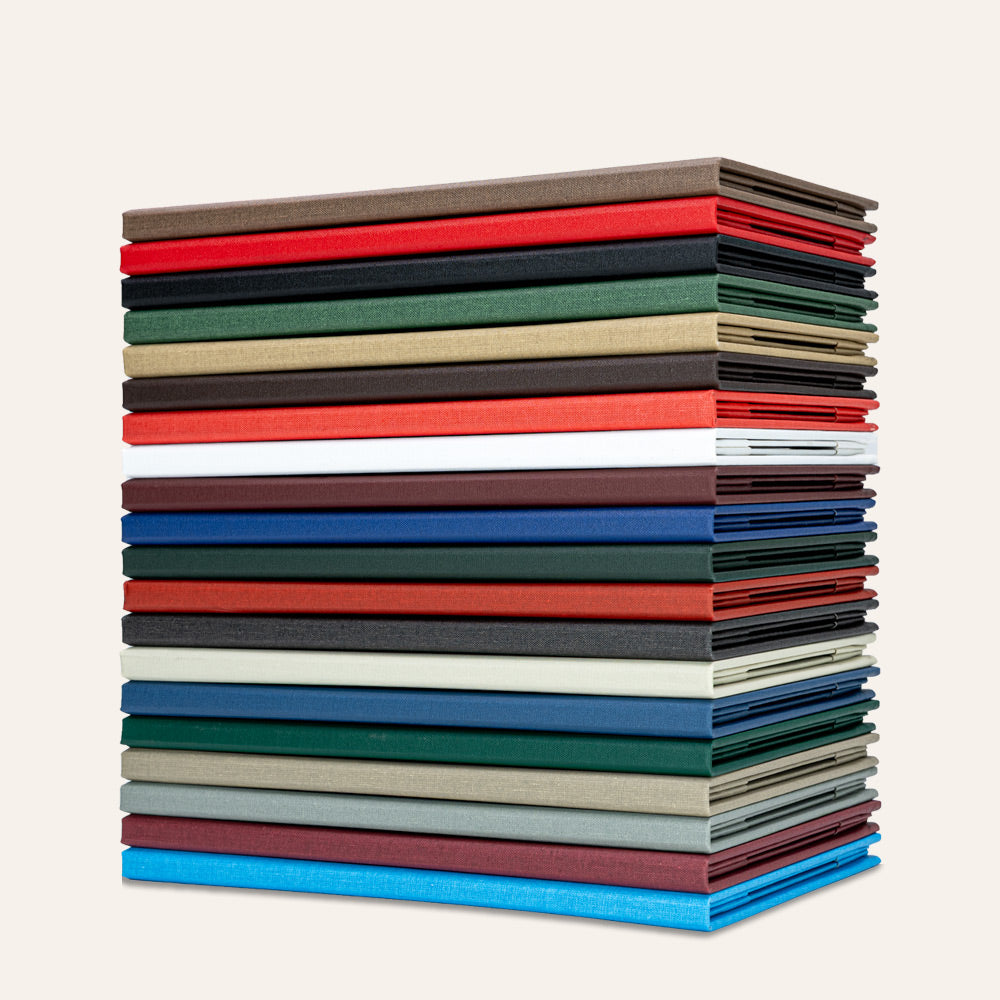 Stack of Arrestox linen menu covers in different colors